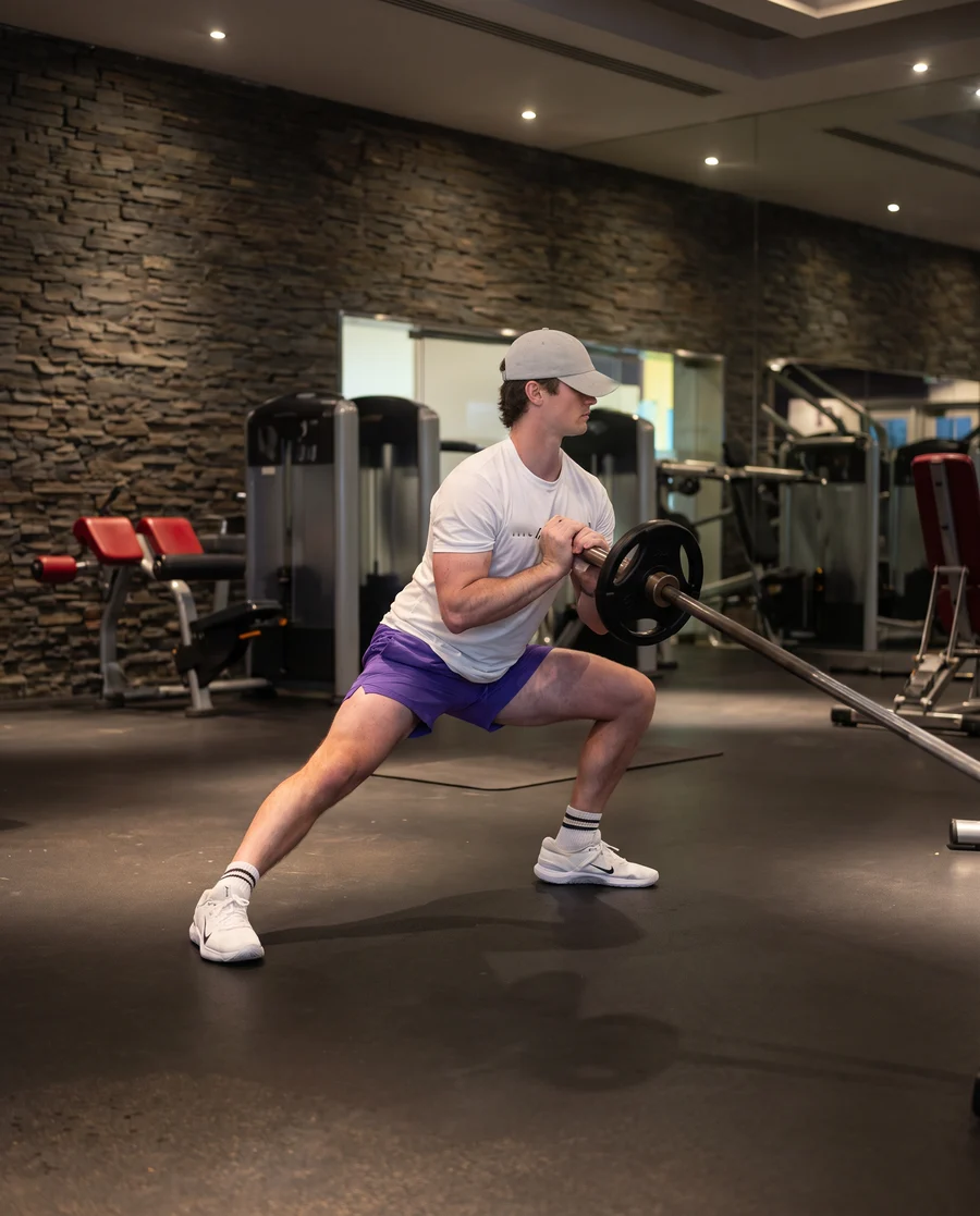 Jamie in a landmine side lunge and press
